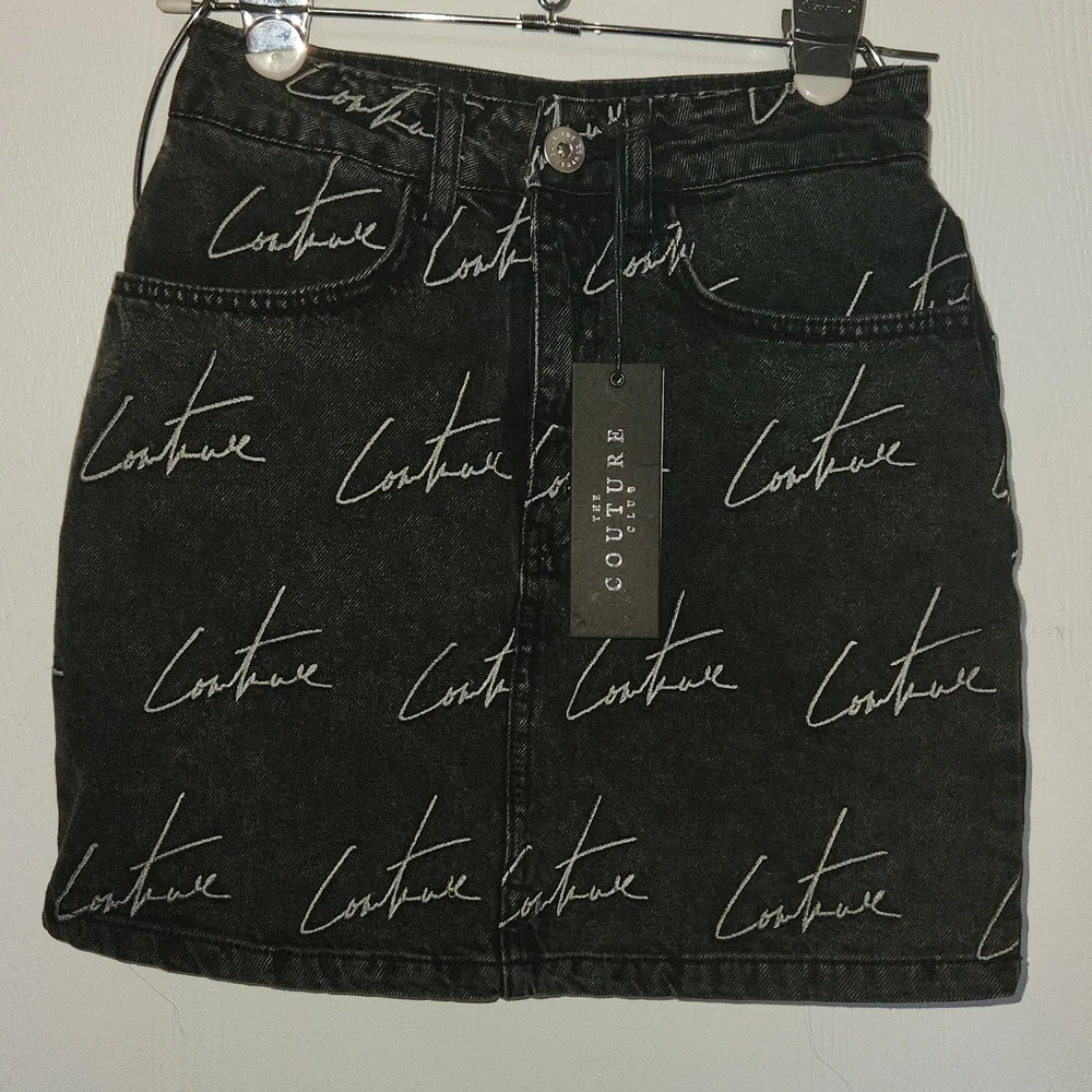 The couture Club Embroidery washed out black Jean Skirt. Size S.